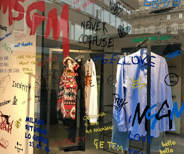 MSGM Milano window by Christian Rizzi - Sticker writing, glass and striped shirt