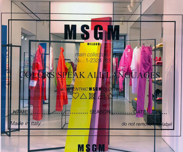 MSGM window display with pink yellow and red colorblock totems, stickers