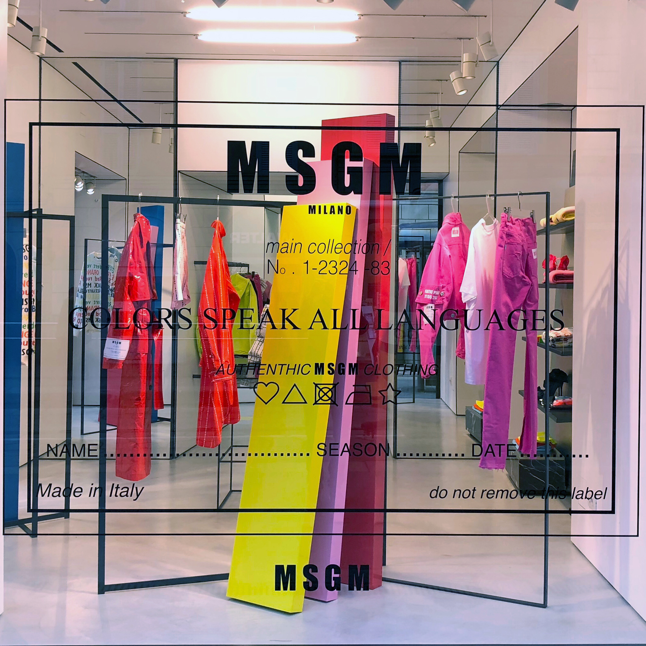 MSGM window display with pink yellow and red colorblock totems, stickers