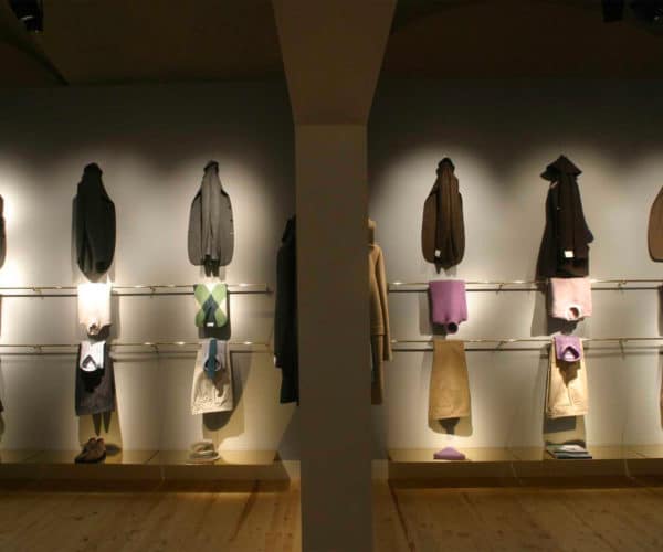 Ballantyne Pitti: hanging cashmere sweaters, grey and brass